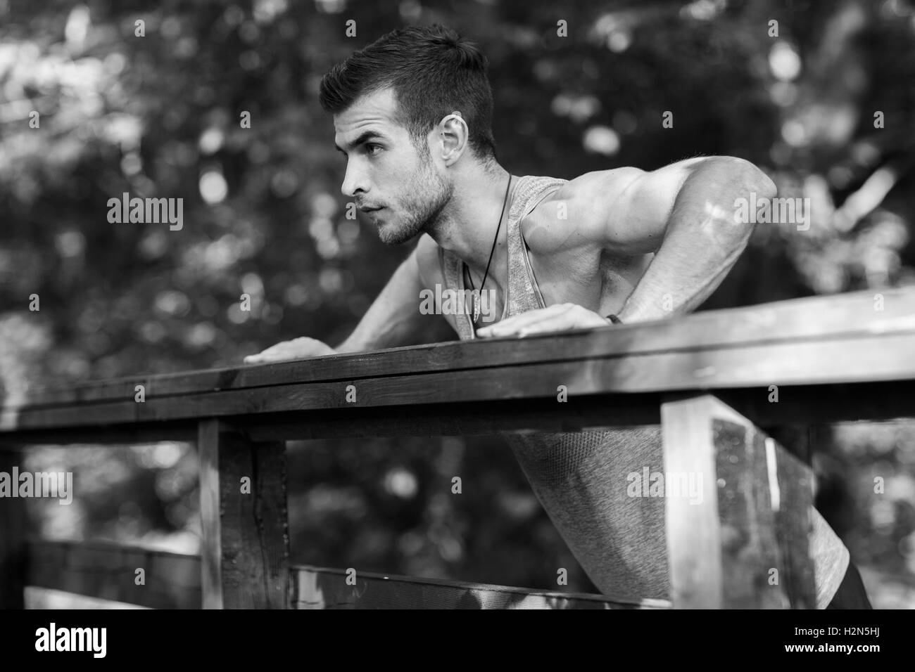 Sportsman doing push-ups exercise,black and white photo Stock Photo