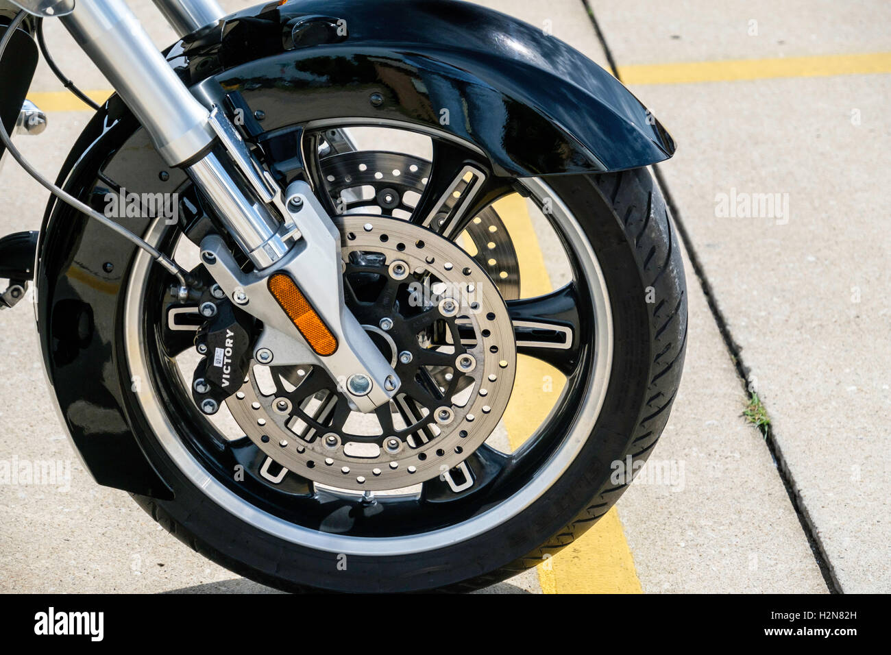 The front wheel of an American made Victory three wheeled motorcycle. Stock Photo