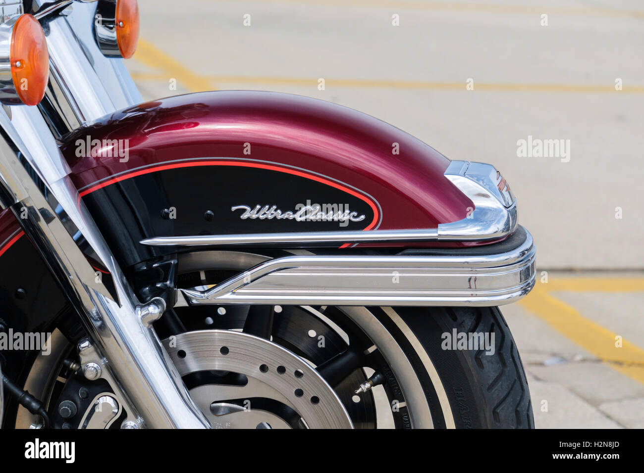 The front wheel of a deep red Harley Davidson Ultra Classic motorcycle, closeup. Oklahoma City, Oklahoma, USA. Stock Photo