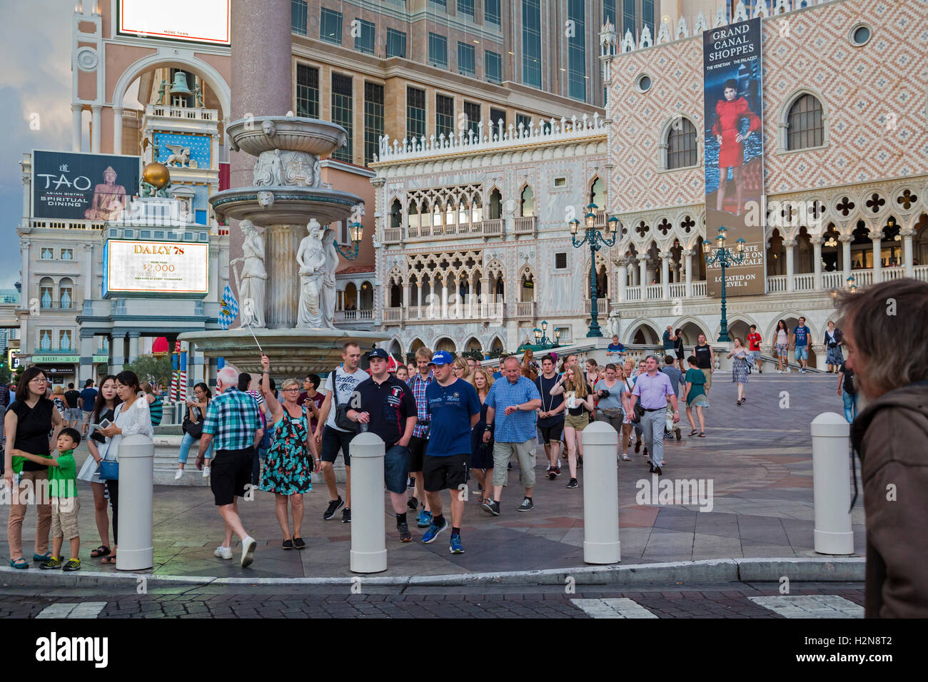 Las Vegas, Nevada - A tour guide waves a flag for her group to follow in front of the Venetian Hotel and Casino. Stock Photo