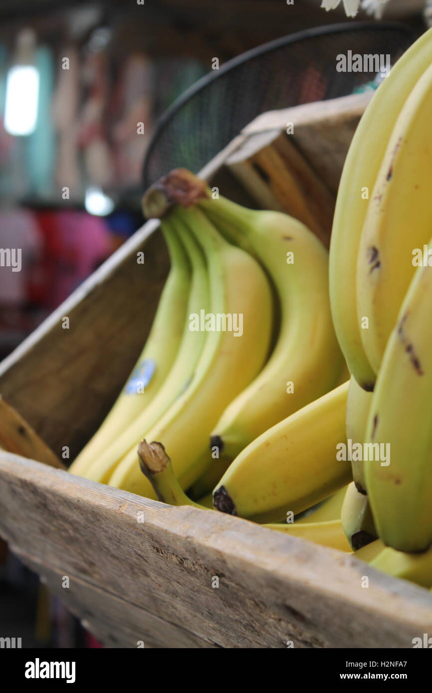 Nearly ripe bunches of bananas in a wooden crate Stock Photo - Alamy