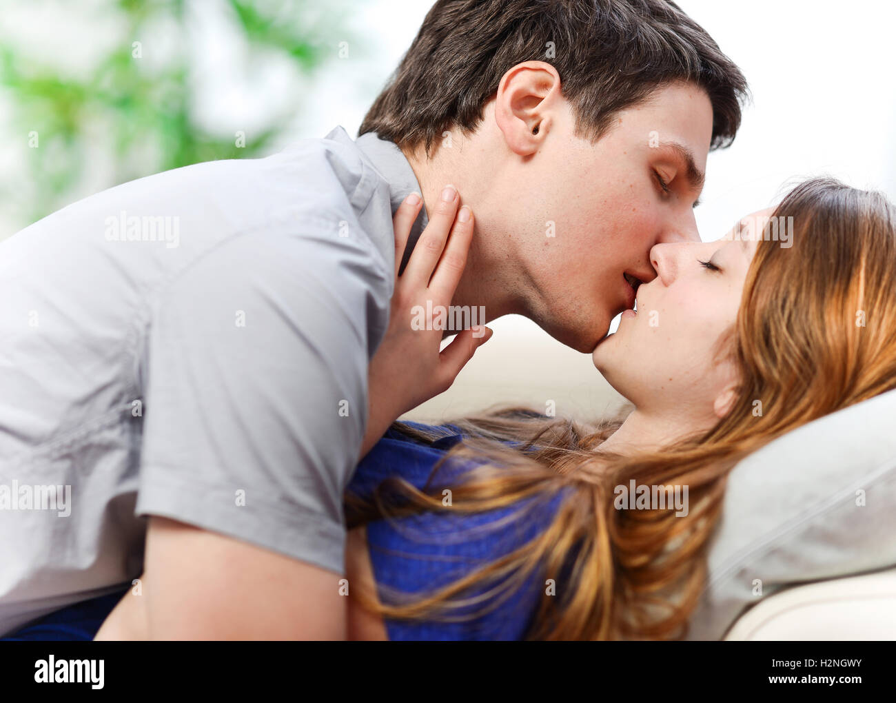 Young lovely couple kissing lovingly hi-res stock photography and
