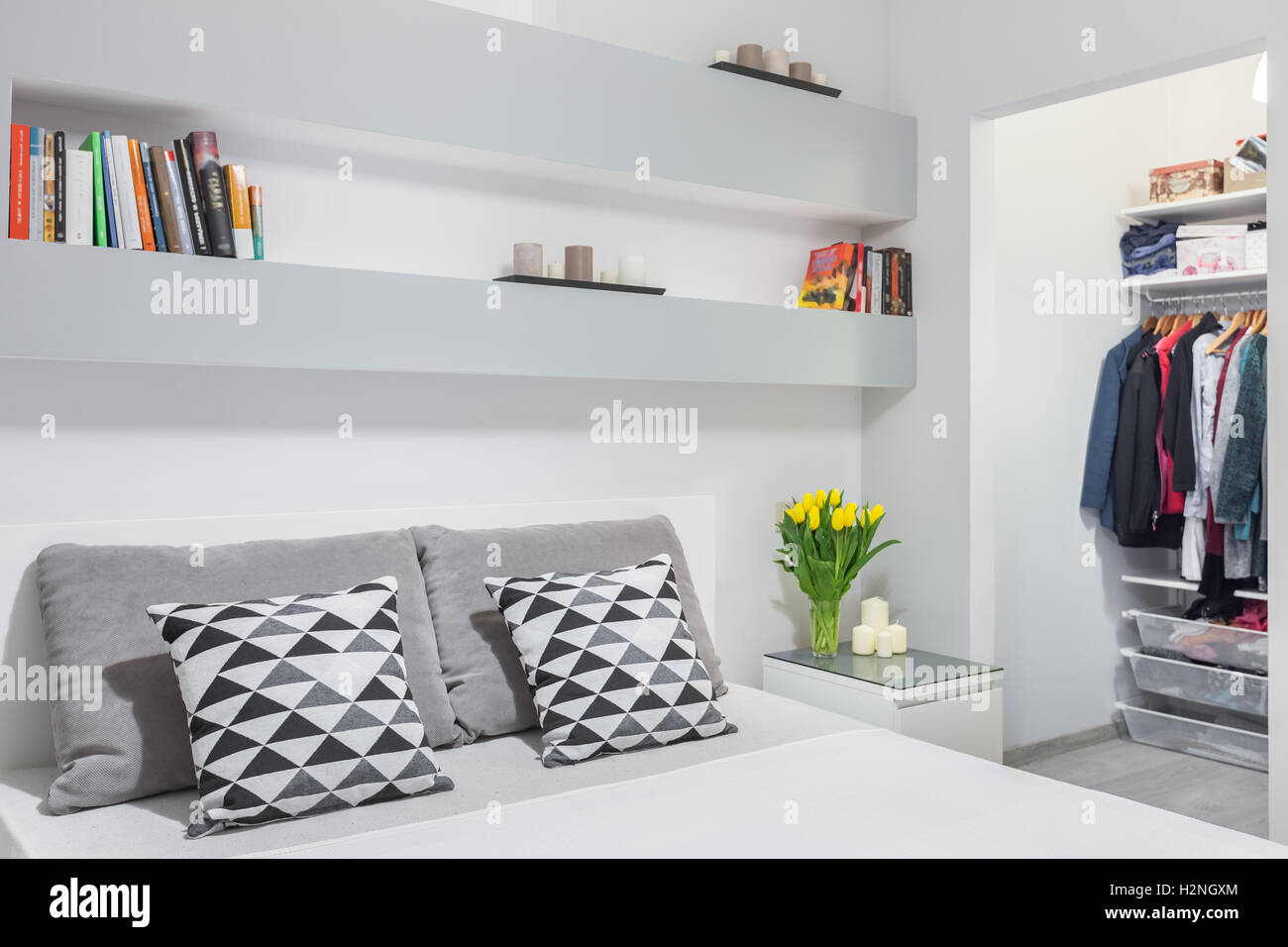 New bedroom in grey and white with double bed and walk in wardrobe Stock Photo
