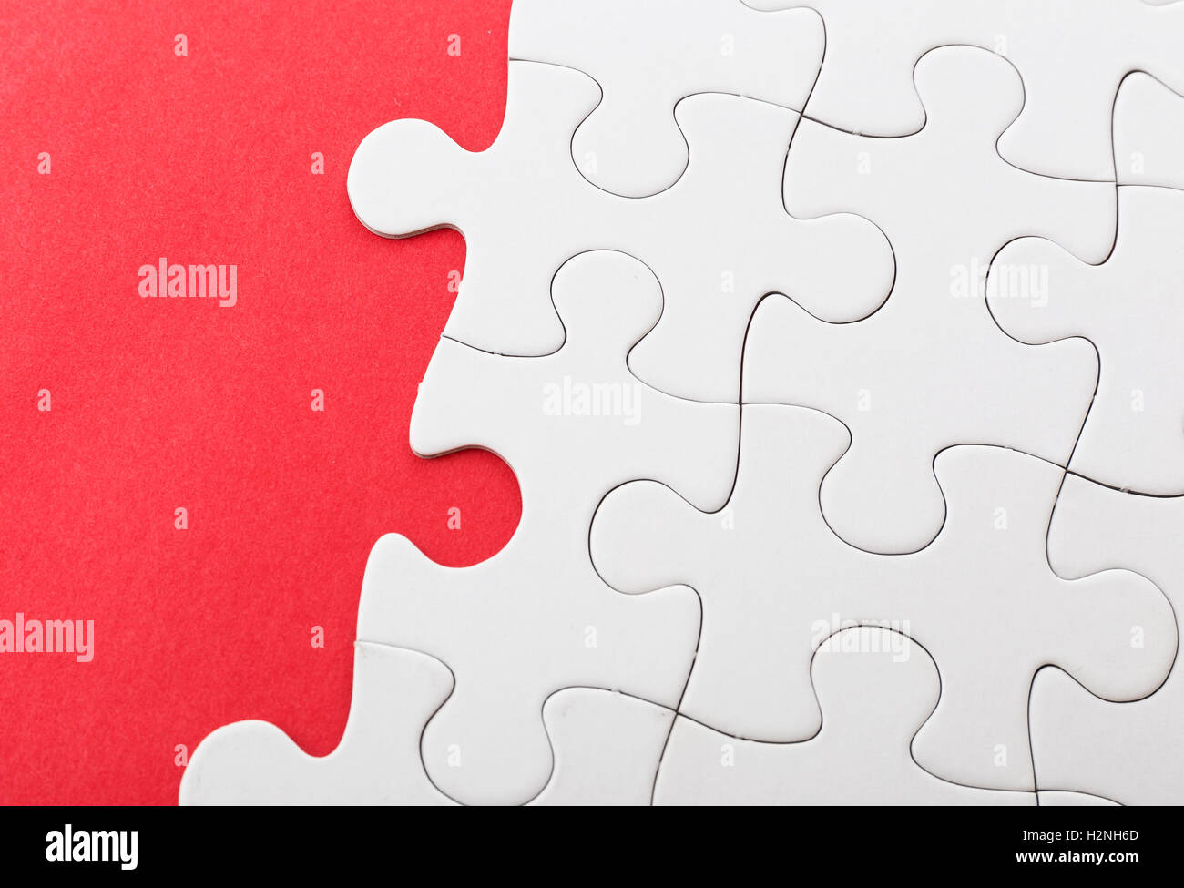 Unfinished puzzle over red background Stock Photo