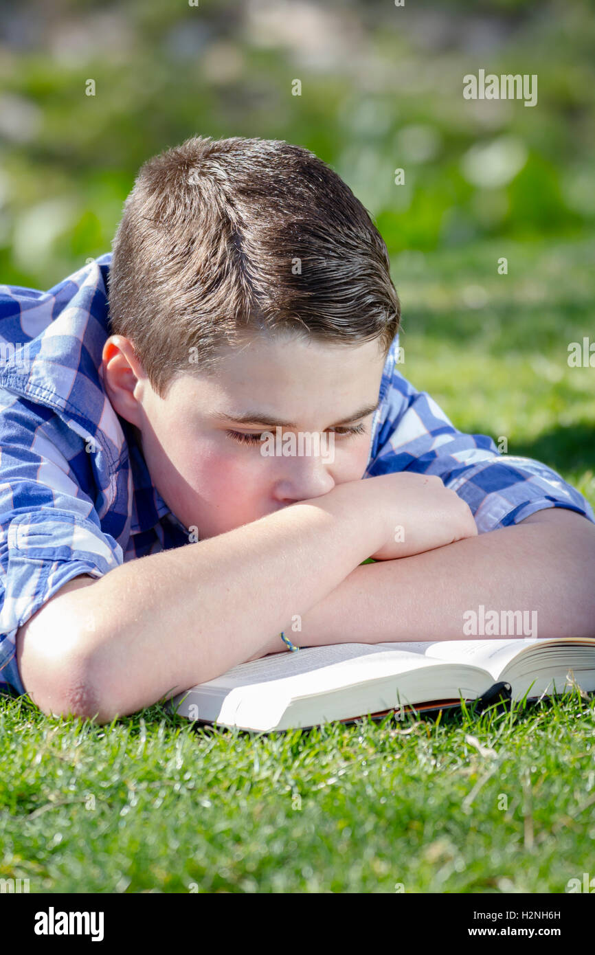 Shallow Reading Young boy reading a book in the woods with shallow depth of fiel Stock ...