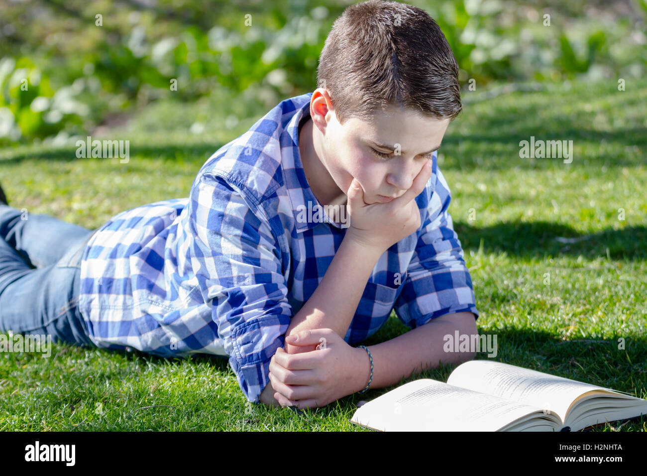 Shallow Reading Young boy reading a book in the woods with shallow depth of fiel Stock ...