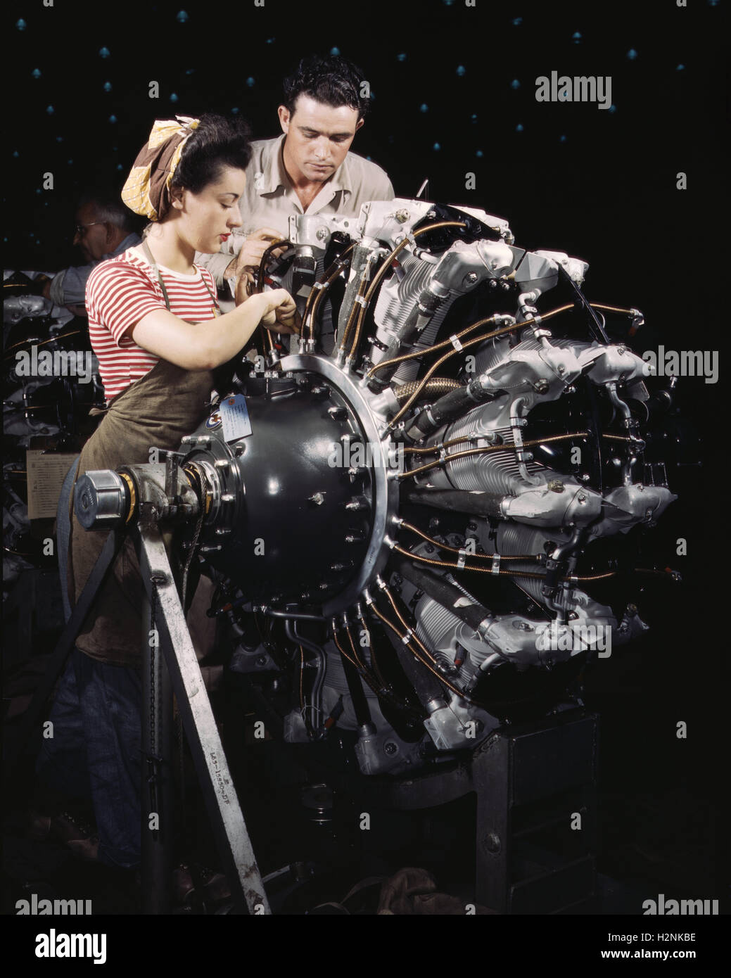 Young Adult Woman being Trained as Engine Mechanic during WWII, Douglas Aircraft Company, Long Beach, California, USA, Alfred T. Palmer, U.S. Office of War Information, October 1942 Stock Photo