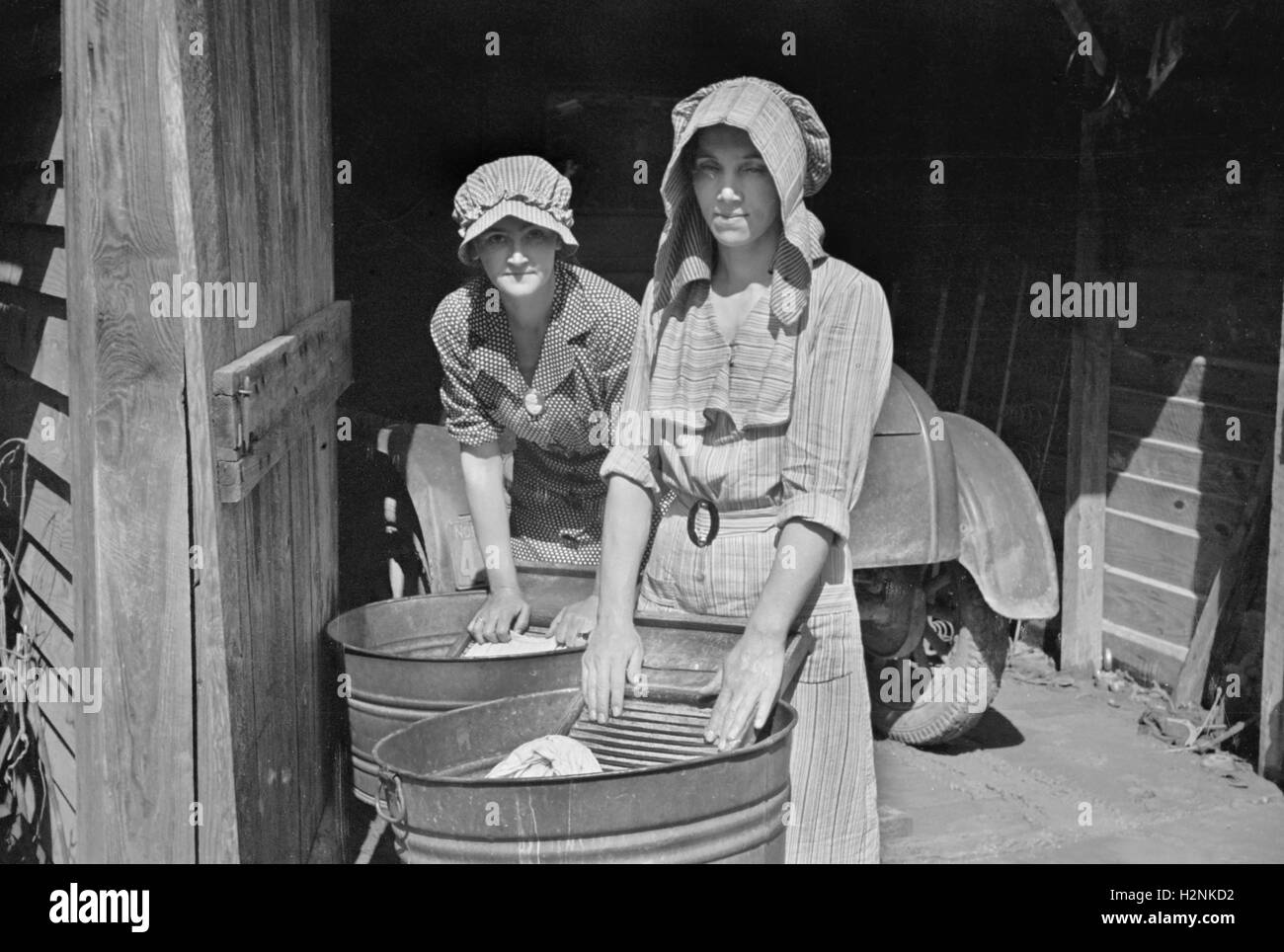 Two Women Washing Clothes, Crabtree Recreational Project, near Raleigh, North Carolina, USA, Carl Mydans for U.S. Resettlement Administration, March 1936 Stock Photo