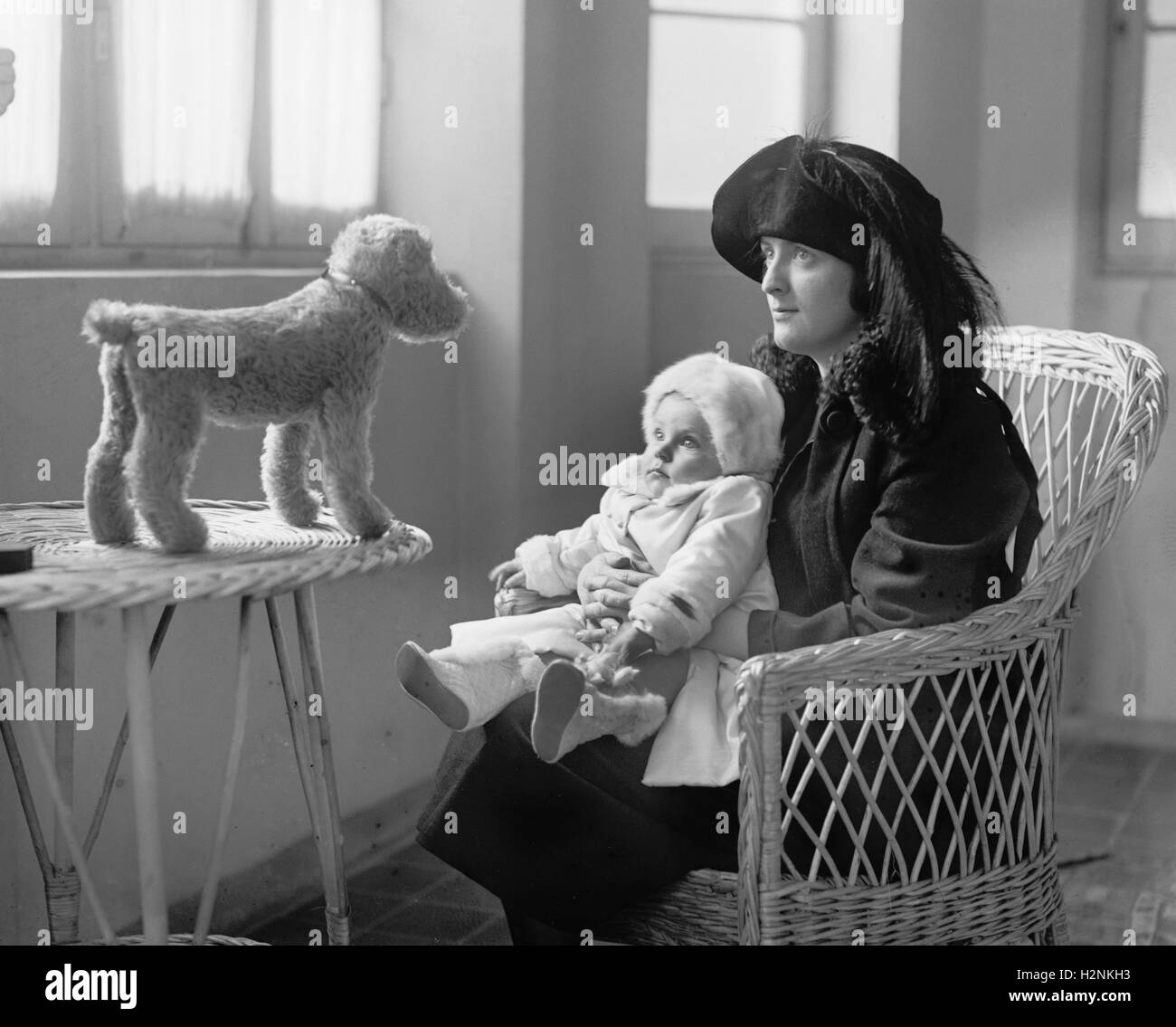Mrs. P.A. Drury and Infant Child Staring at Stuffed Toy Dog, National Photo Company, 1922 Stock Photo
