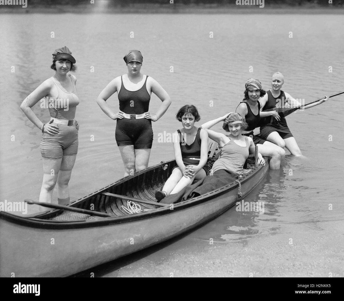 Actress Kay Laurel (seated with hat) and Group of Women in Bathing Suits Posing with Canoe at Bathing Beach, Washington DC, USA, National Photo Company, July 1922 Stock Photo