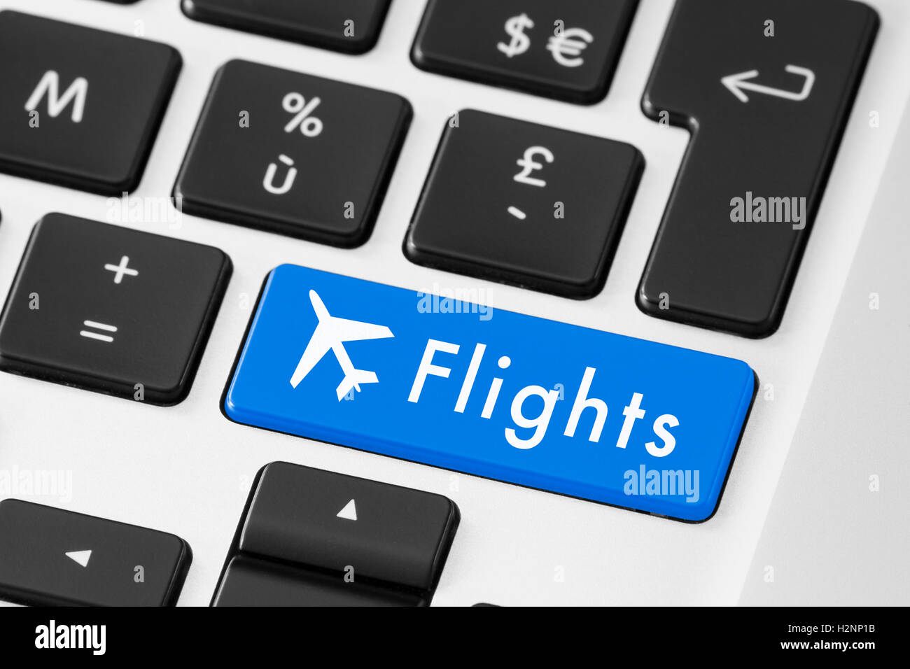 Close-up of blue flights button on keyboard for online check-in Stock Photo