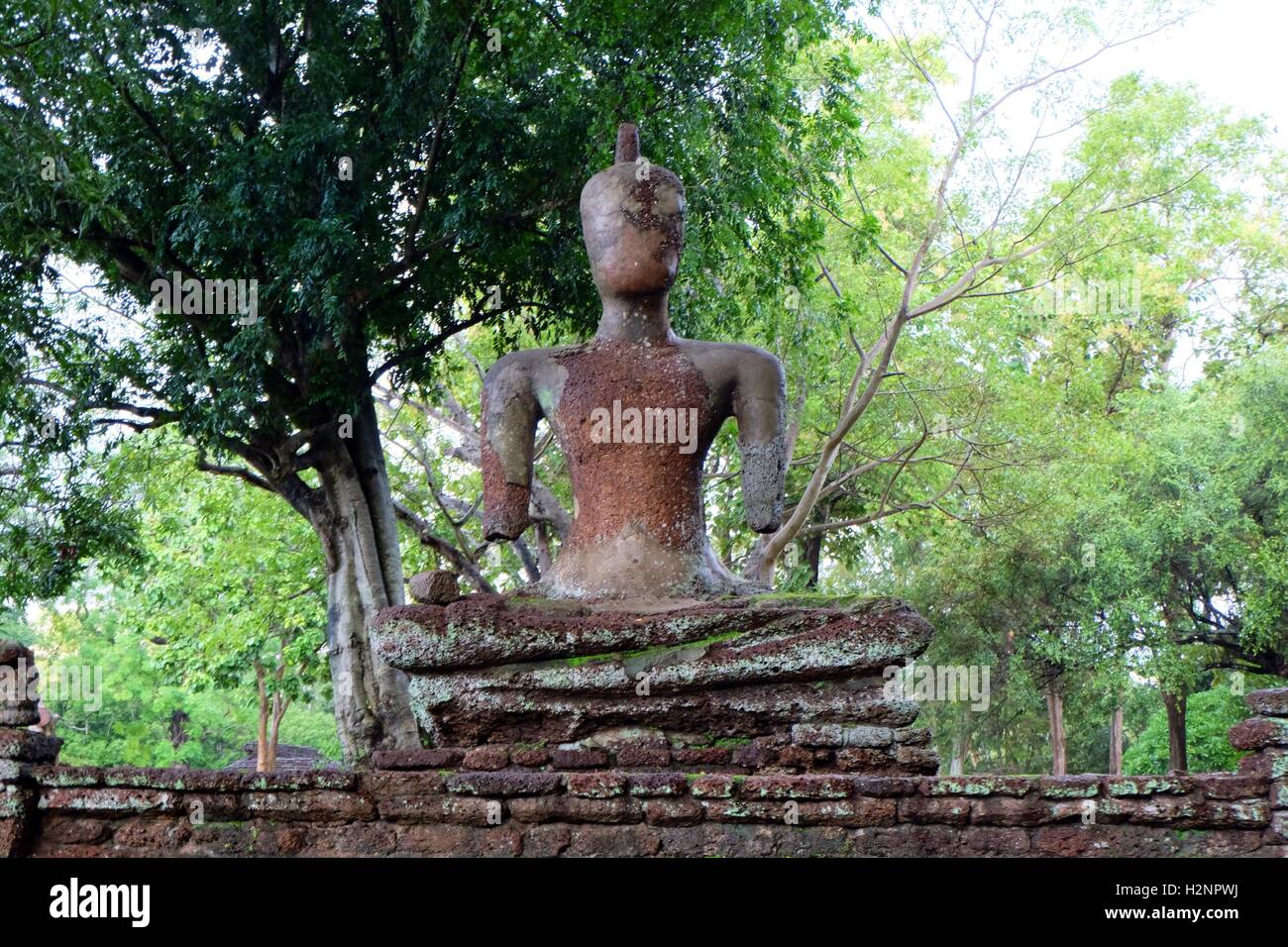 Sitting broken Bouddha statue at Kamphaeng Phet historical park Stock Photo