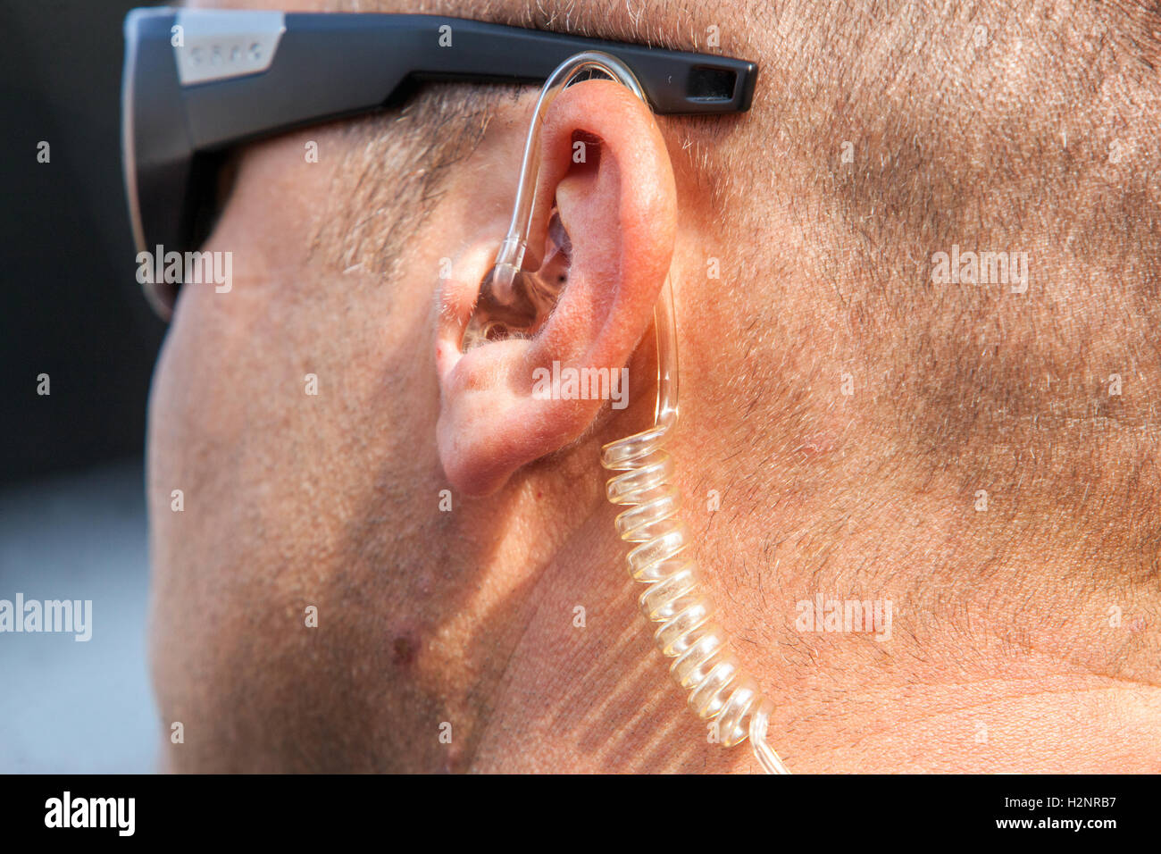 The security guard and earpiece, detail ear Stock Photo
