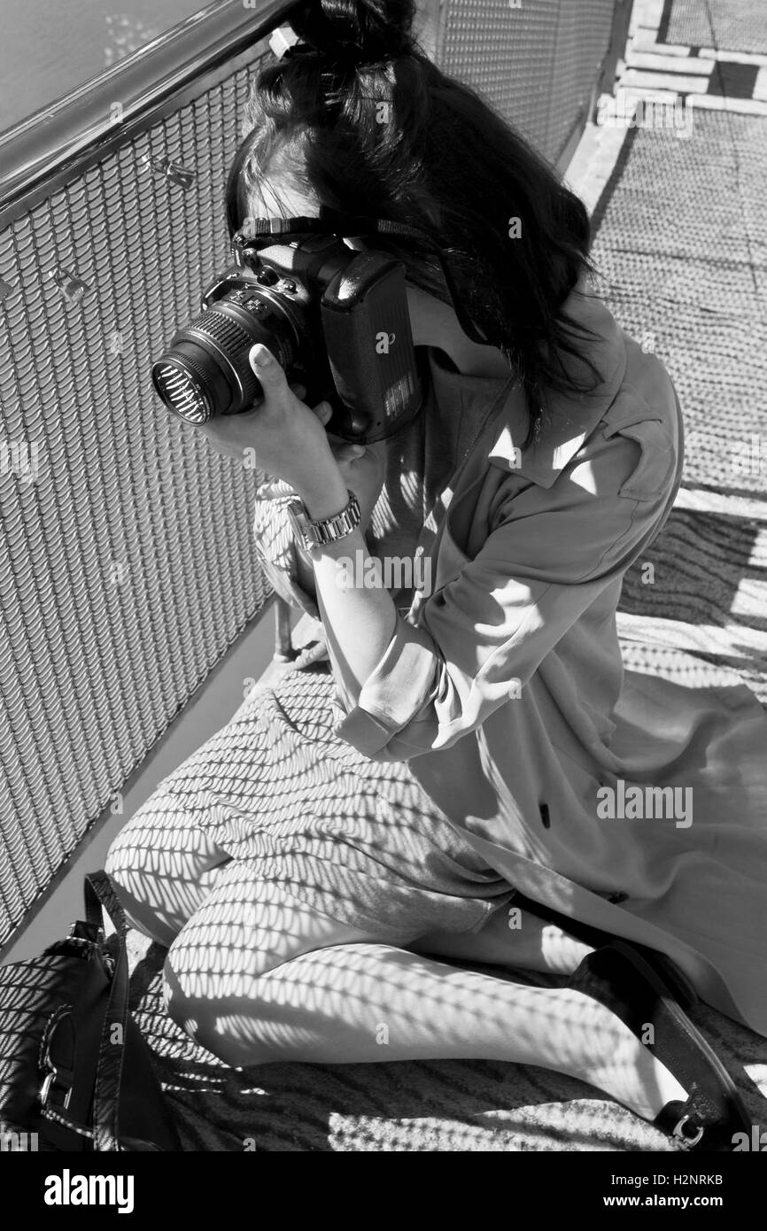 Ffion Edwards photographing the river on the bridge in Bristol City Centre, Stock Photo