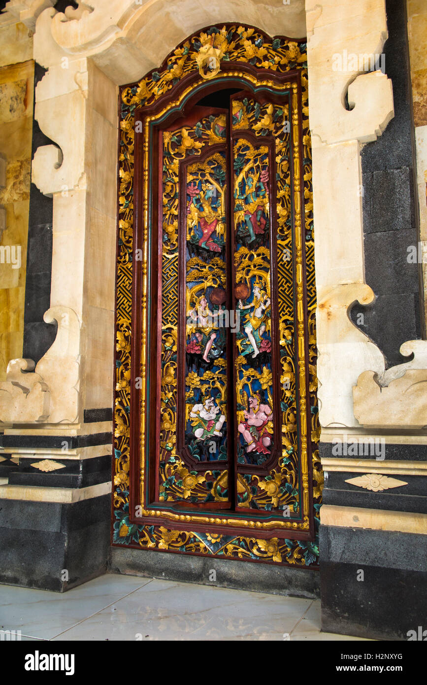 Indonesia, Bali, Tengannan, Bali Aga village, decoratively carved painted doorway in wealthy house compaund Stock Photo