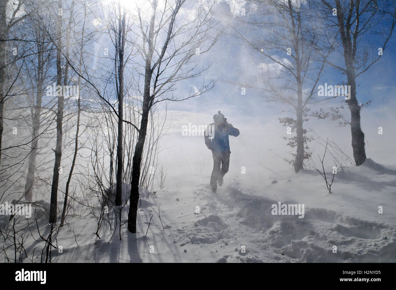 Person is breaking through blizzard. Stock Photo