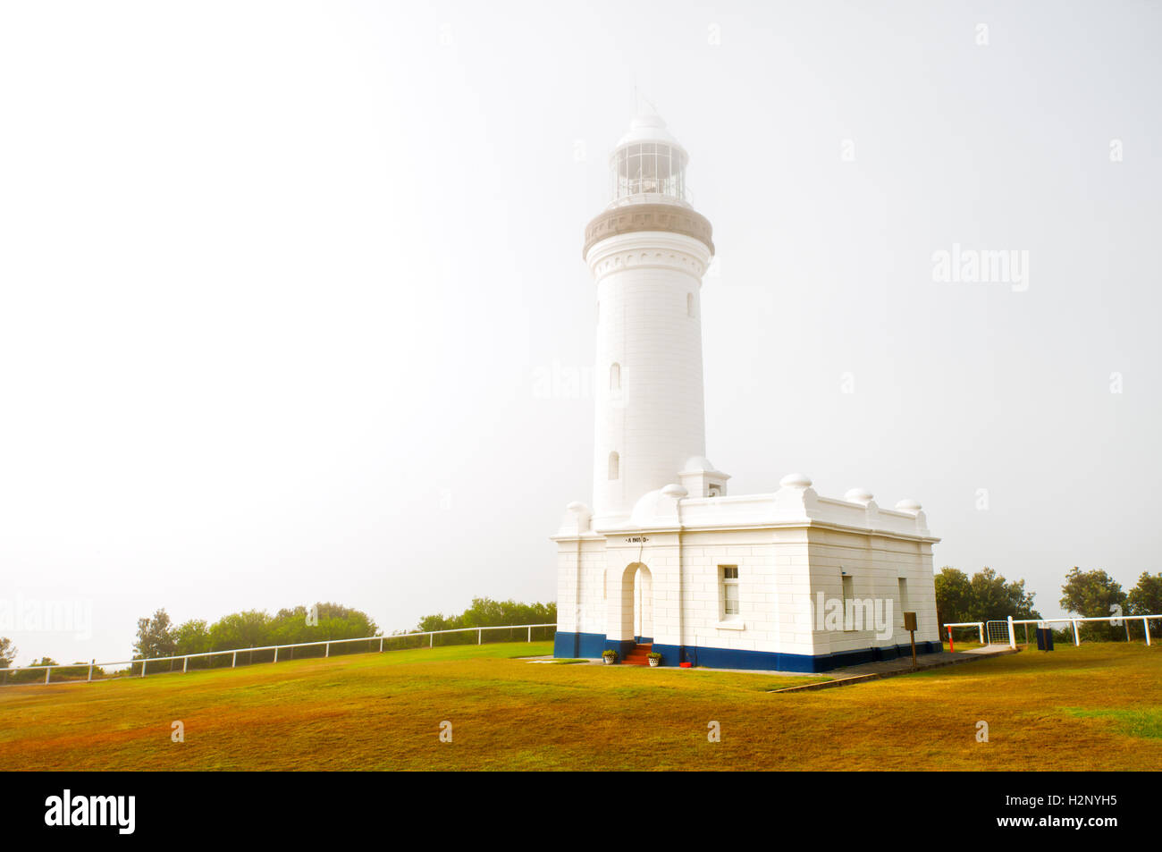 Norah Head Lighthouse in early morning mist. Stock Photo