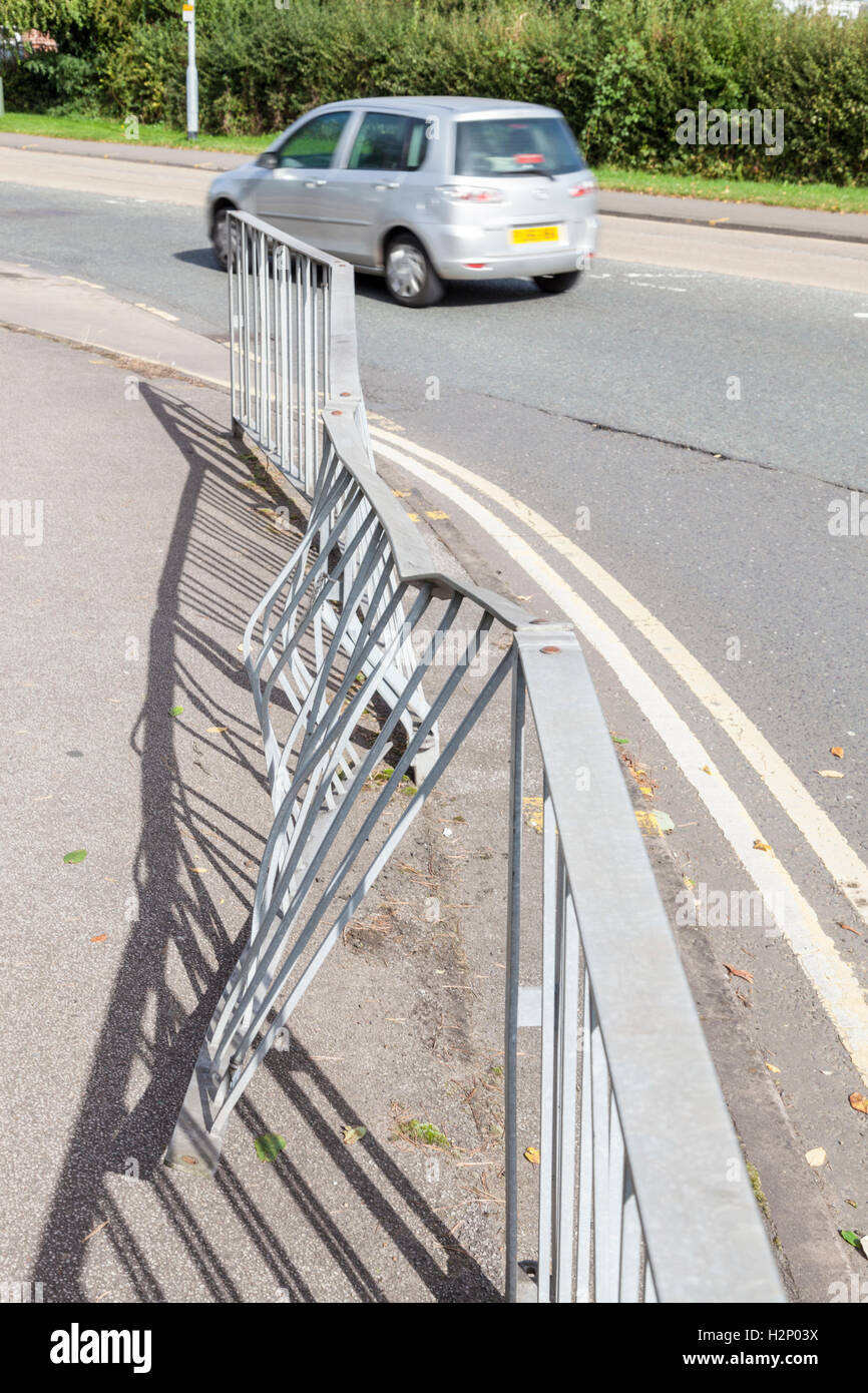 Damaged guardrailing or guard railing between the pavement and road following a collision, Nottinghamshire, England, UK Stock Photo
