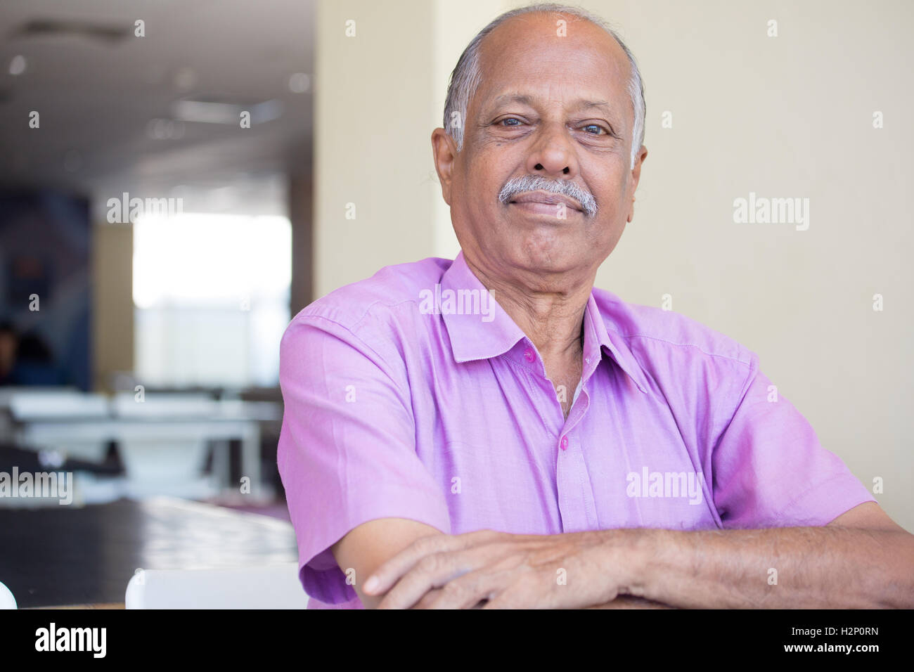 Closeup headshot portrait of elderly gentleman arms crossed folded, in