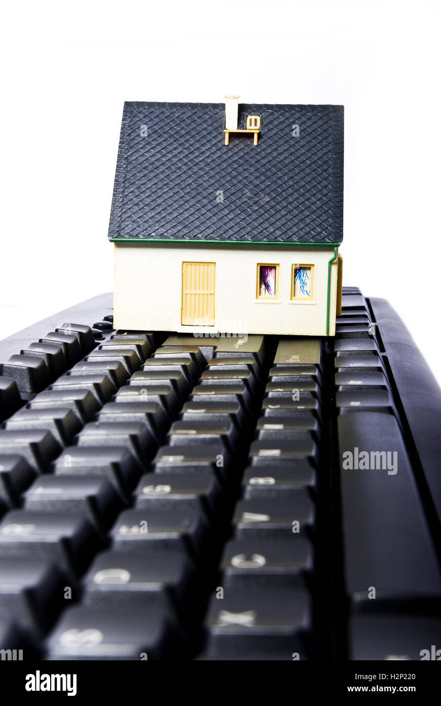 model house on keyboard with white background Stock Photo Alamy