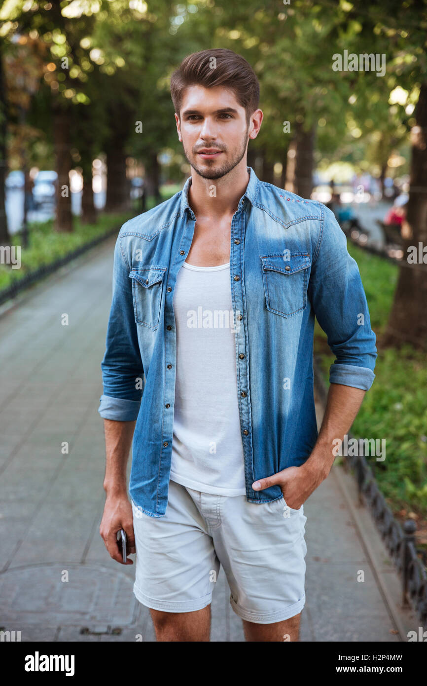 Handsome young man standing on the street Stock Photo - Alamy