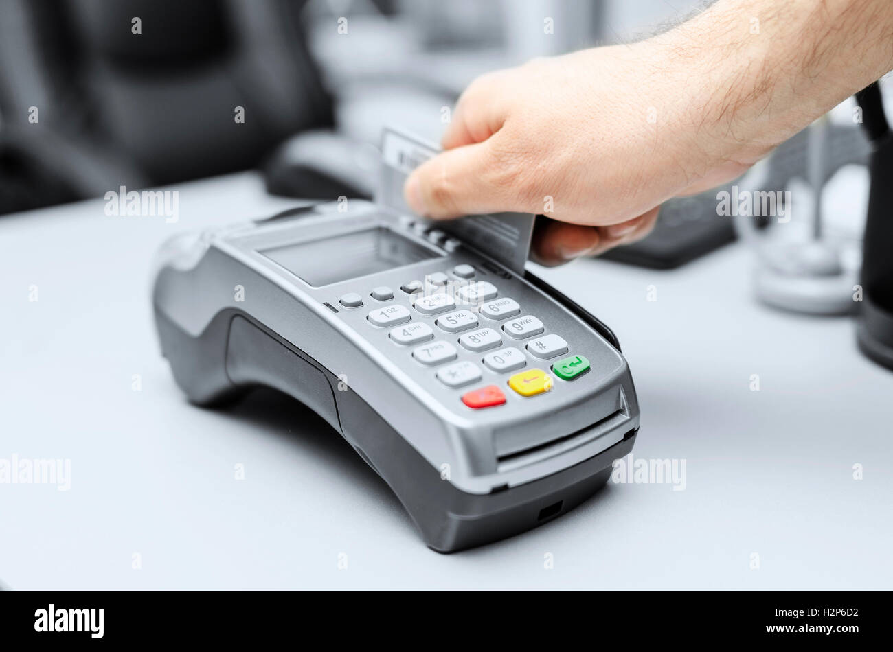 Bank terminal and a man's hand with a credit or debit card to make ...