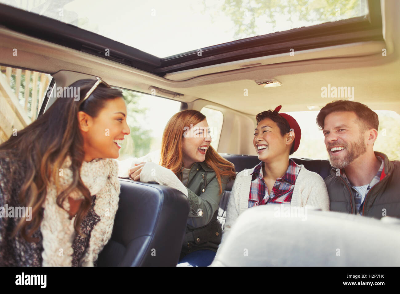 Couples riding and laughing in car Stock Photo