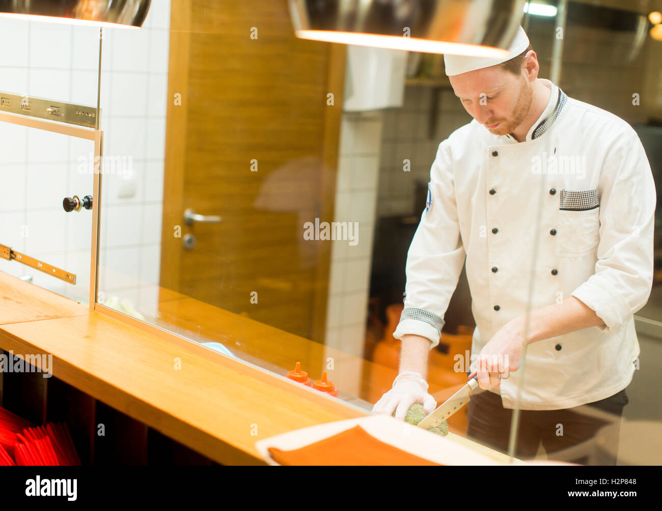 Chef preparing food in the kitchen at the restaurant Stock Photo