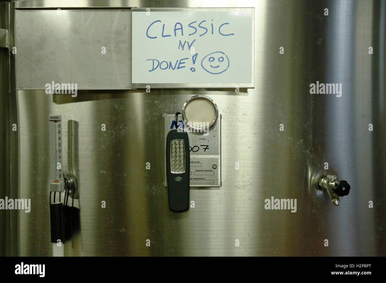 A vat of sparkling wine is labelled 'done' at the winery of Hambledon Vineyard situated on the South Downs Stock Photo