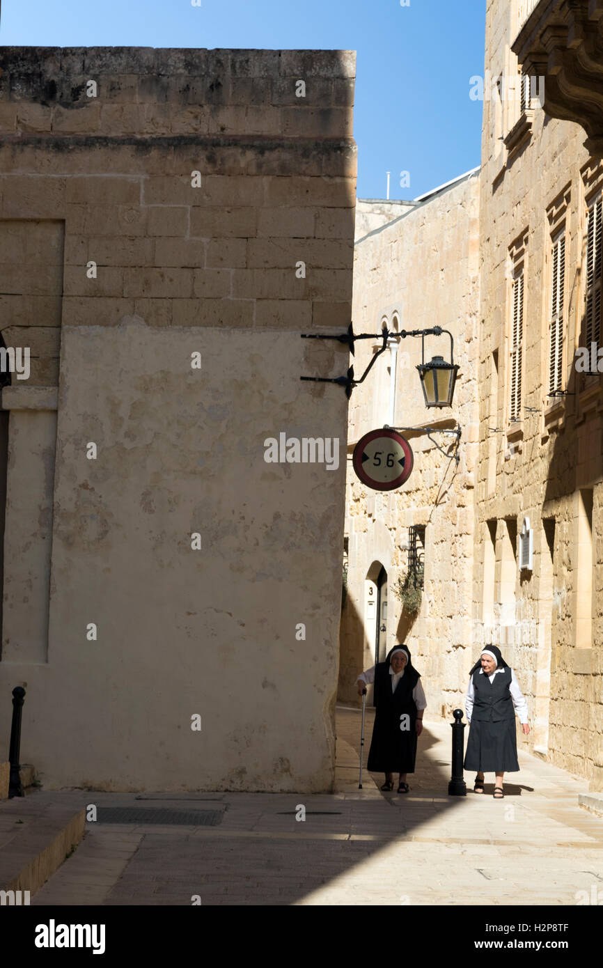 Two nuns strolling in Mdina, Malta Stock Photo