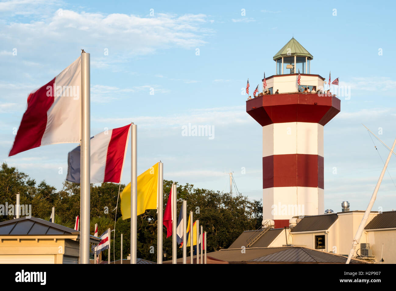 Flags Flying at Harbour Town Lighthouse in Sea Pines Resort on Hilton Head Island, South Carolina Stock Photo