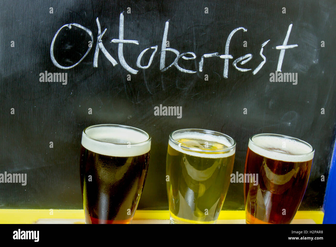 Flight of assorted Oktoberfest beers with chalkboard. Stock Photo