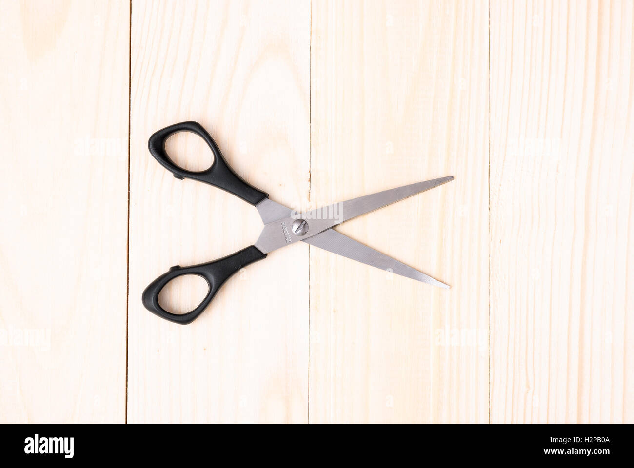 Scissors on wooden background Stock Photo