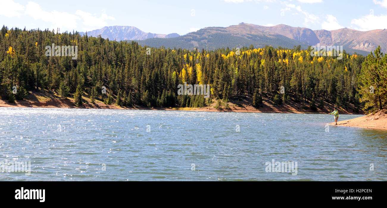 Fisherman on the South Catamount Reservoir in Colorado, with Pikes Peak