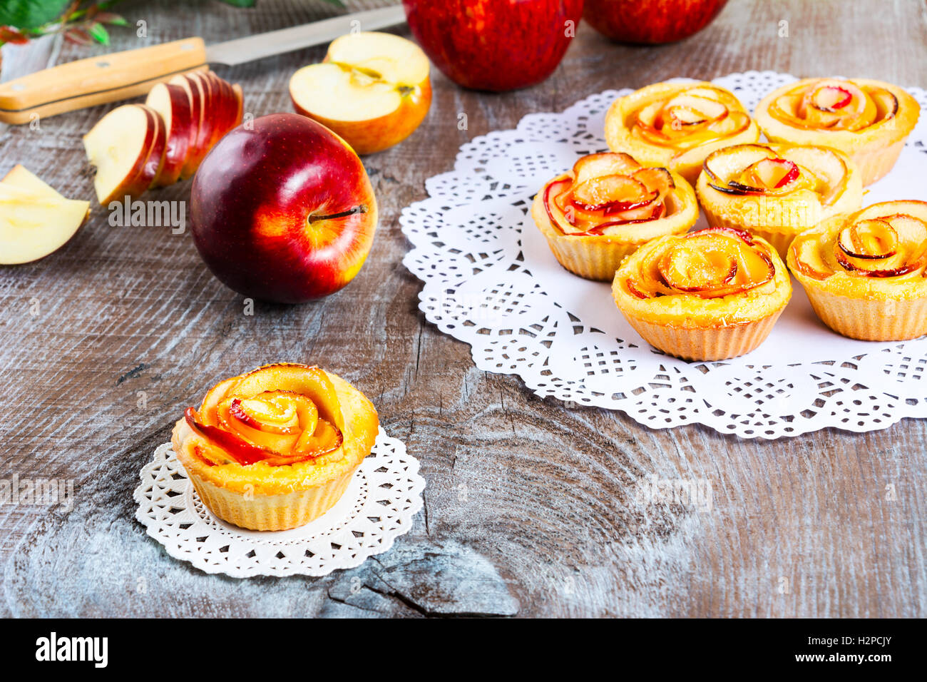 Muffin with rose shaped apple. Sweet apple dessert pie. Homemade apple
