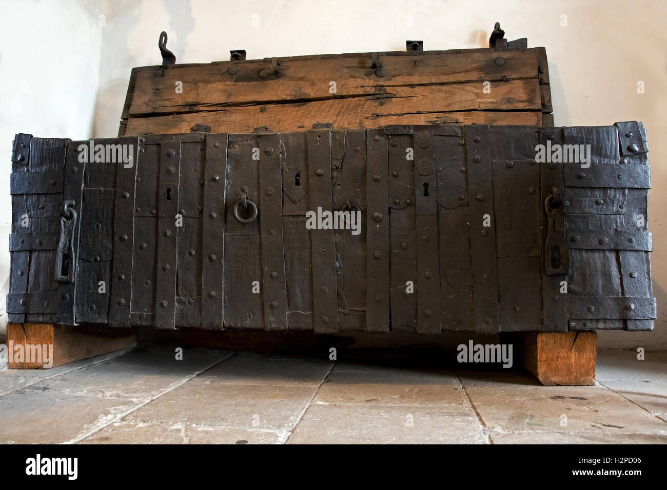 The old wooden chest in the room. Medieval chests with iron decorations. Stock Photo