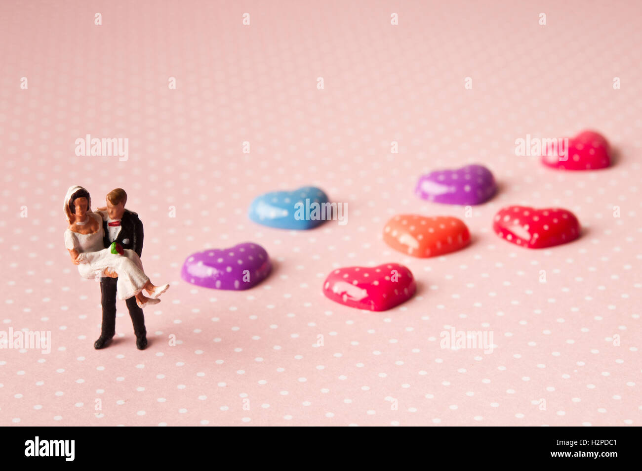 figurines of bride and groom with valentine hearts, love and marriage concept Stock Photo