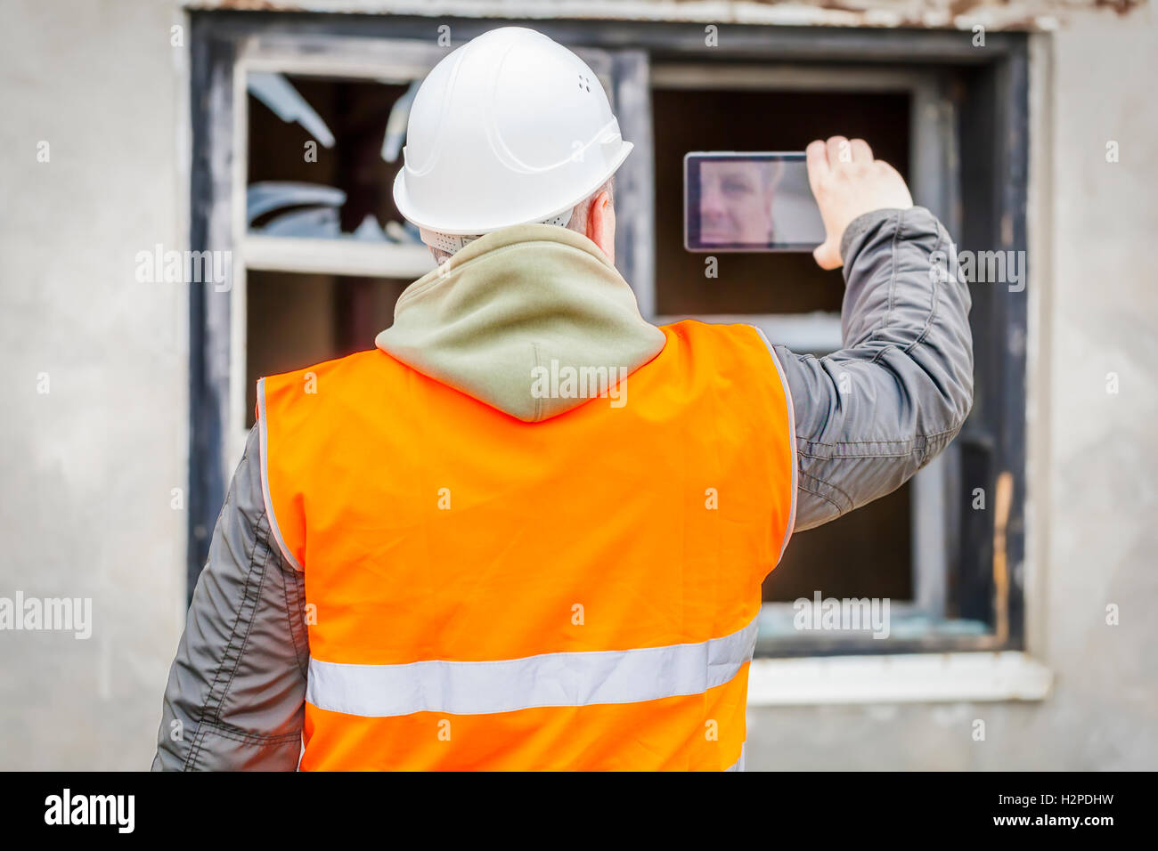 Construction inspector filming with cell phone near building Stock ...