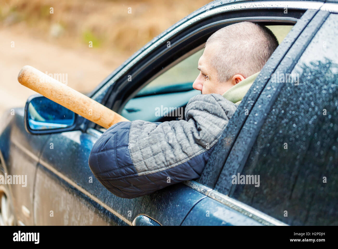 Aggressive man with a baseball bat in car Stock Photo Alamy