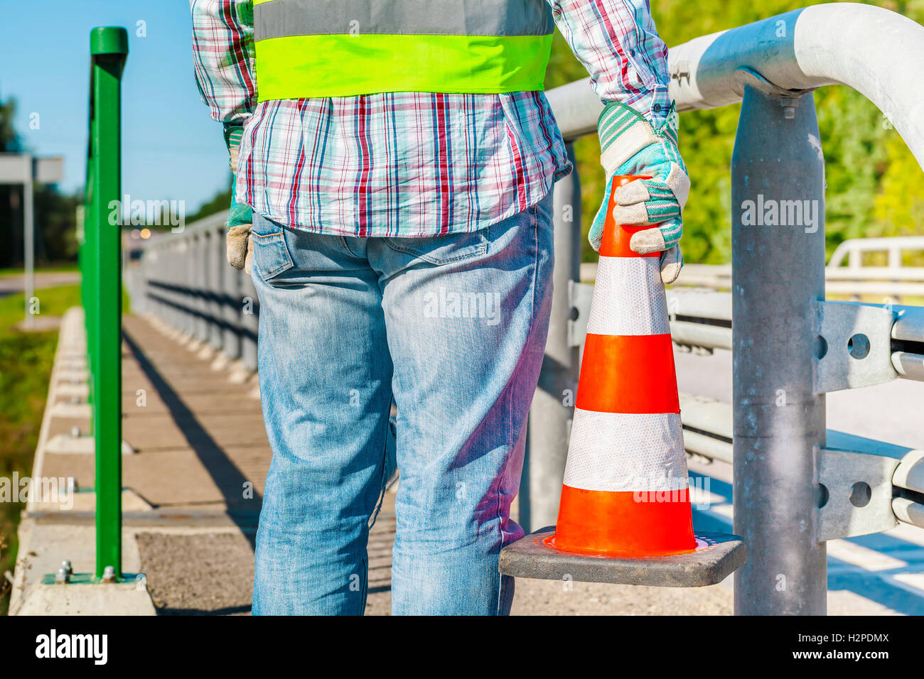 Road construction worker with traffic cone near highway Stock Photo - Alamy