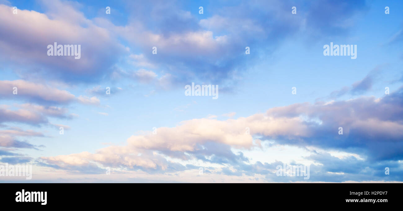 Clouds over blue sky in summer evening, background texture Stock Photo