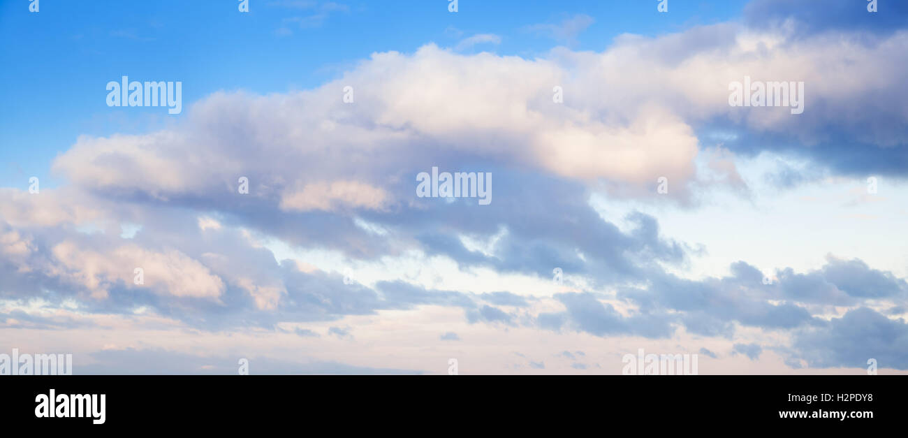 Clouds over blue sky in summer evening, background photo texture Stock Photo