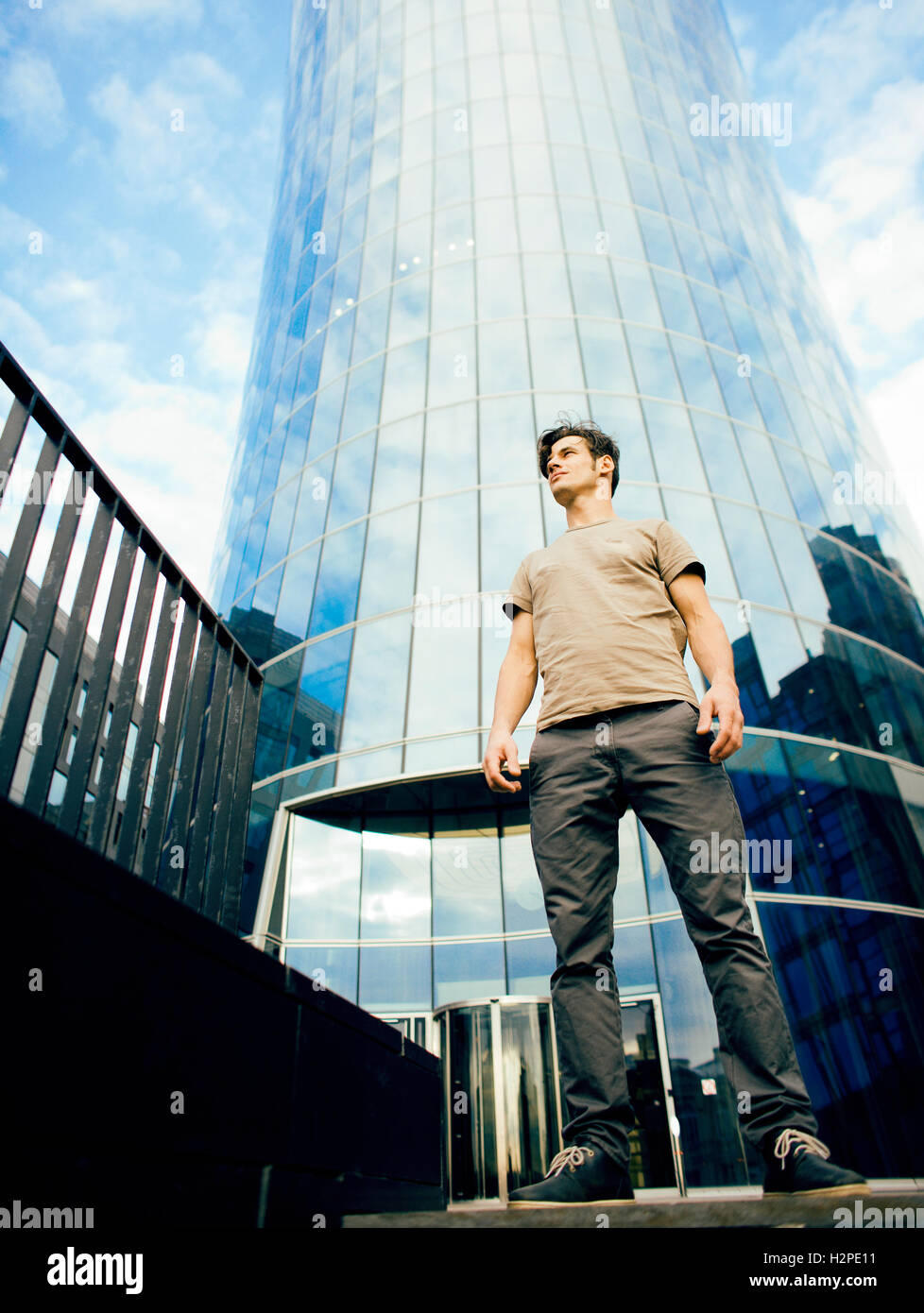 Man In Building real young man stand in front of modern business building Stock Photo ...