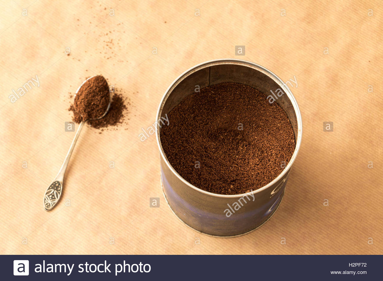 Container With Ground Coffee And A Spoon Powder On Brown Paper Background Container With Ground Coffee And A Spoon Powder On Brown Paper Background