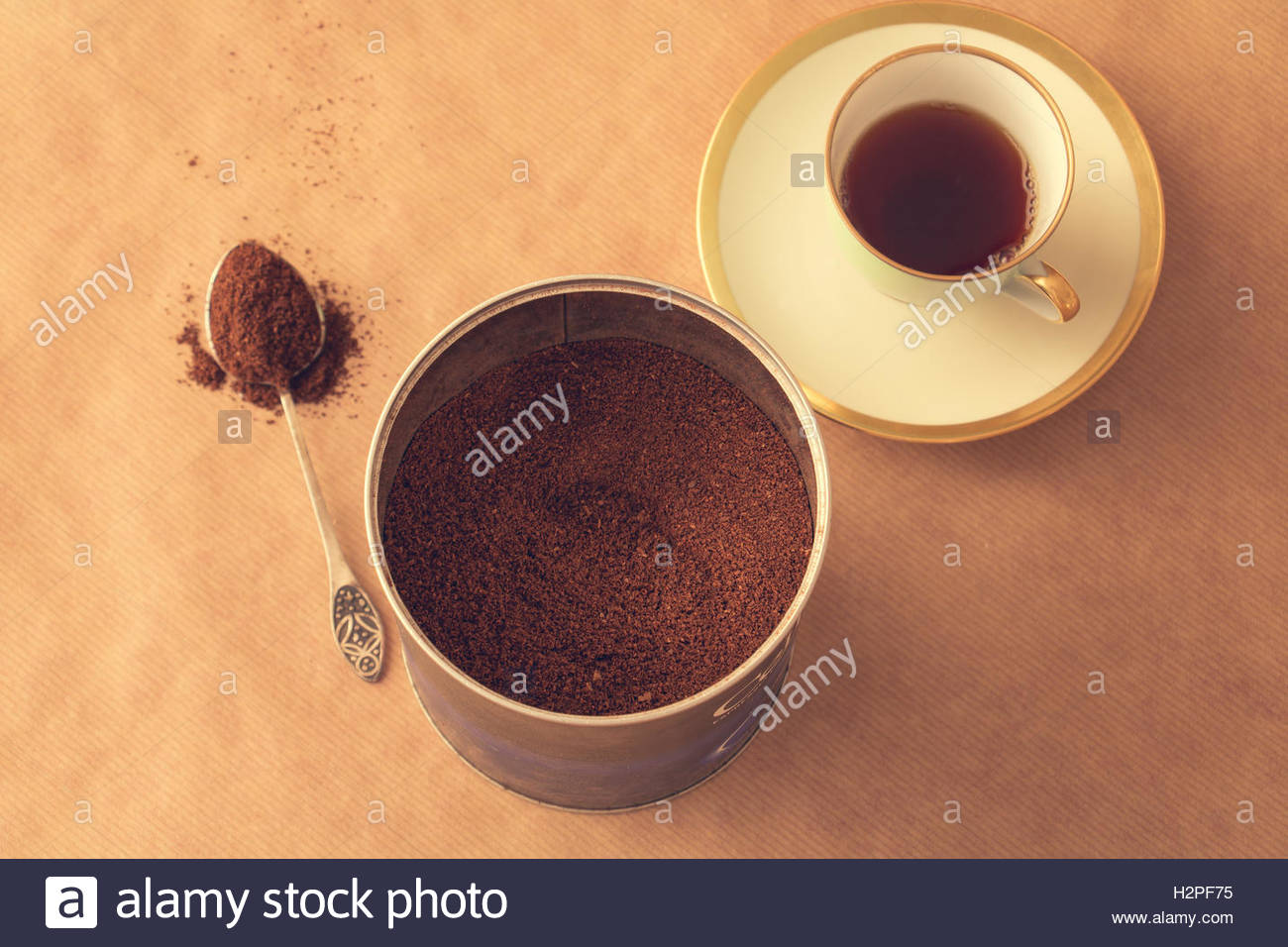 Container With Ground Coffee A Spoon Powder And Cup Of On Brown Paper Background Container With Ground Coffee A Spoon Powder And Cup Of On Brown Paper Background