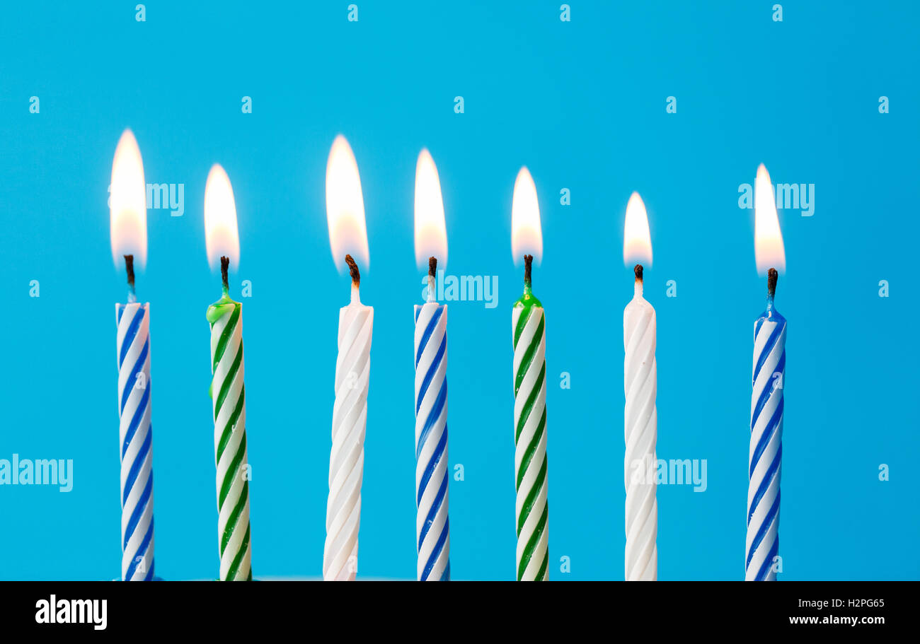 birthday candles burning over blue background Stock Photo - Alamy
