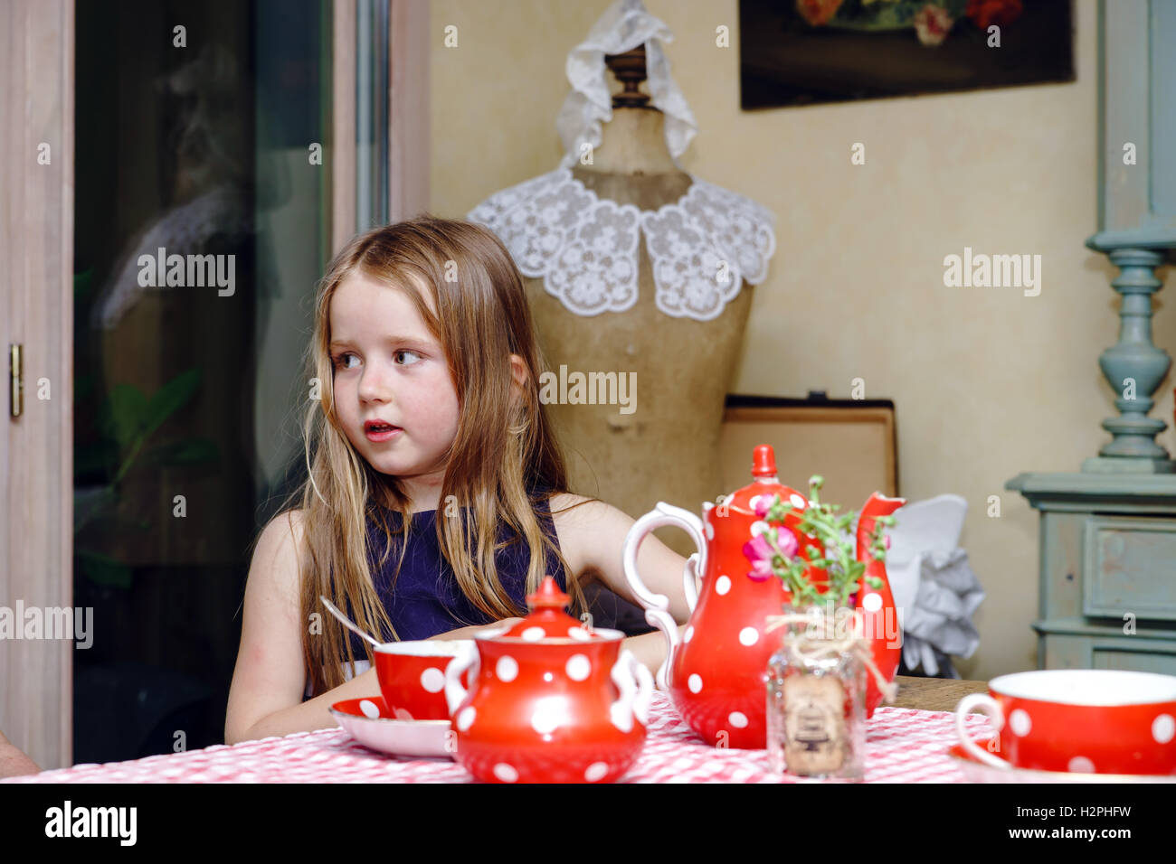 Cute little girl preparing tea hires stock photography and images Alamy