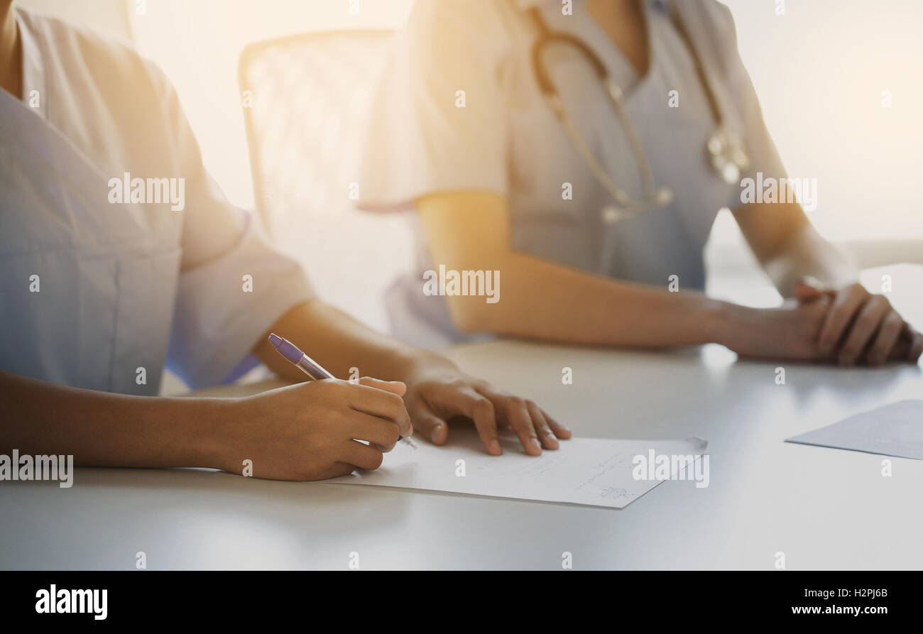 close up of doctor taking notes at hospital Stock Photo - Alamy