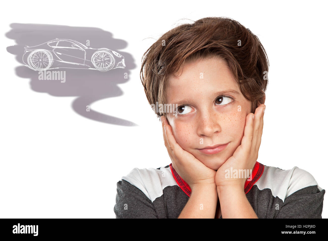 Closeup portrait of a cute teen boy dreaming about a car, thoughtful child isolated on white background, great boyish wish Stock Photo