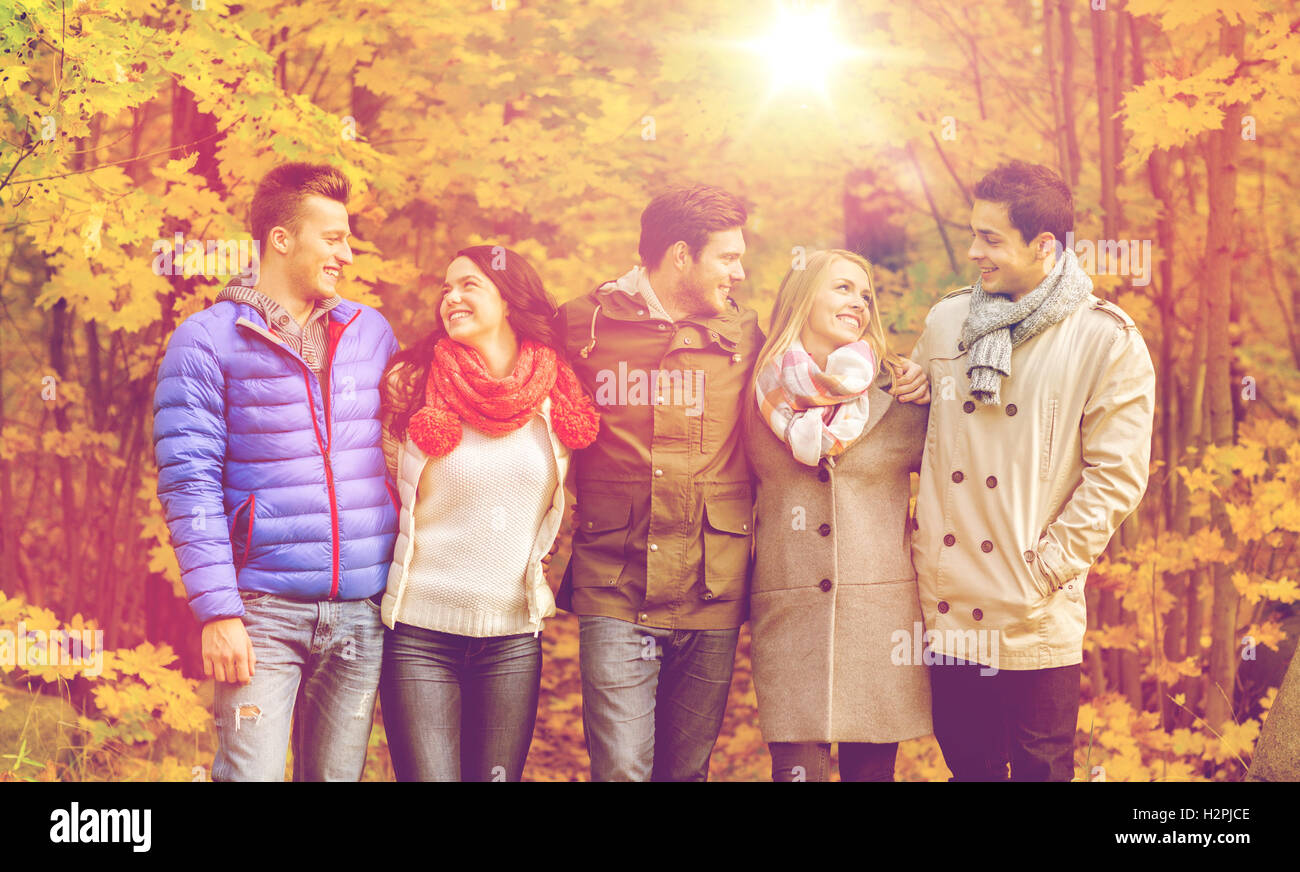 group of smiling men and women in autumn park Stock Photo - Alamy